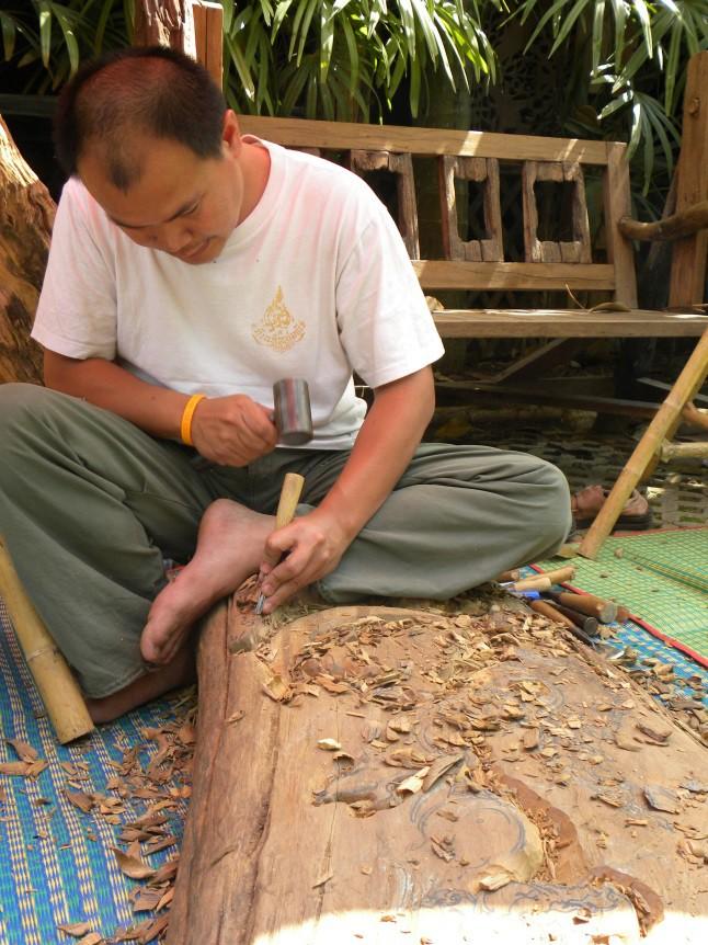 The artisan of Ban Thawai is working on wood and a completed piece of wood art with natural look.